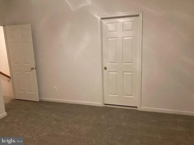 an empty room with closet area