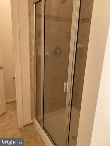 a bathroom with a glass door shower