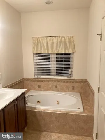 a bathroom with a bathtub and a table
