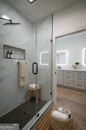 a bathroom with a sink a toilet and shower