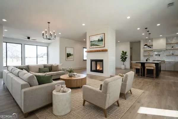 a living room with furniture fireplace and window