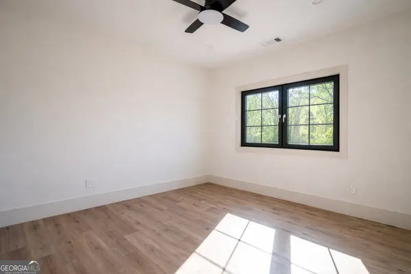 wooden floor in an empty room with a window