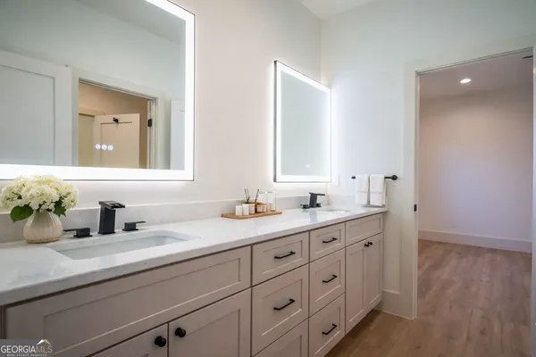 a bathroom with double sink and a mirror