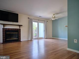99 Carousel Circle Doylestown, PA 18901 - Photo 2 of 14 a view of an empty room with wooden floor fireplace and a window