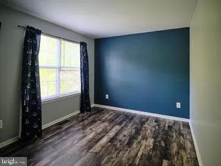 an empty room with windows and closet