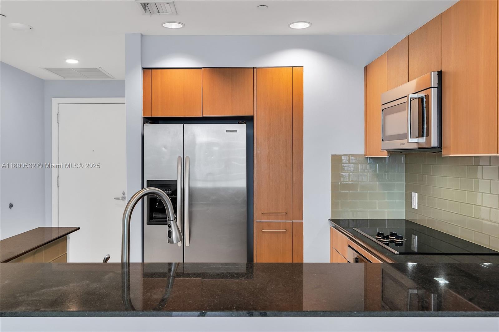 1060 Brickell Avenue, Unit 1811 Miami, FL 33131 - Photo 14 of 43 a kitchen with stainless steel appliances granite countertop a refrigerator and a stove
