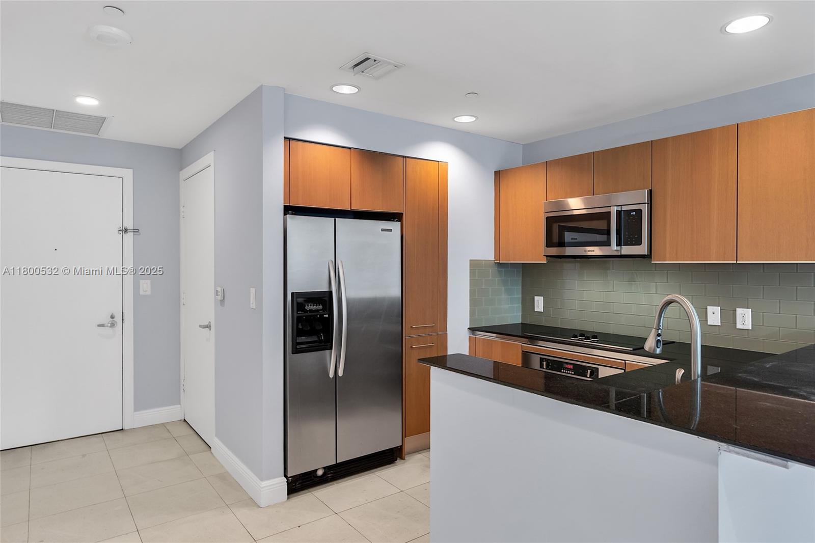 1060 Brickell Avenue, Unit 1811 Miami, FL 33131 - Photo 15 of 43 a kitchen with stainless steel appliances granite countertop a refrigerator and a sink