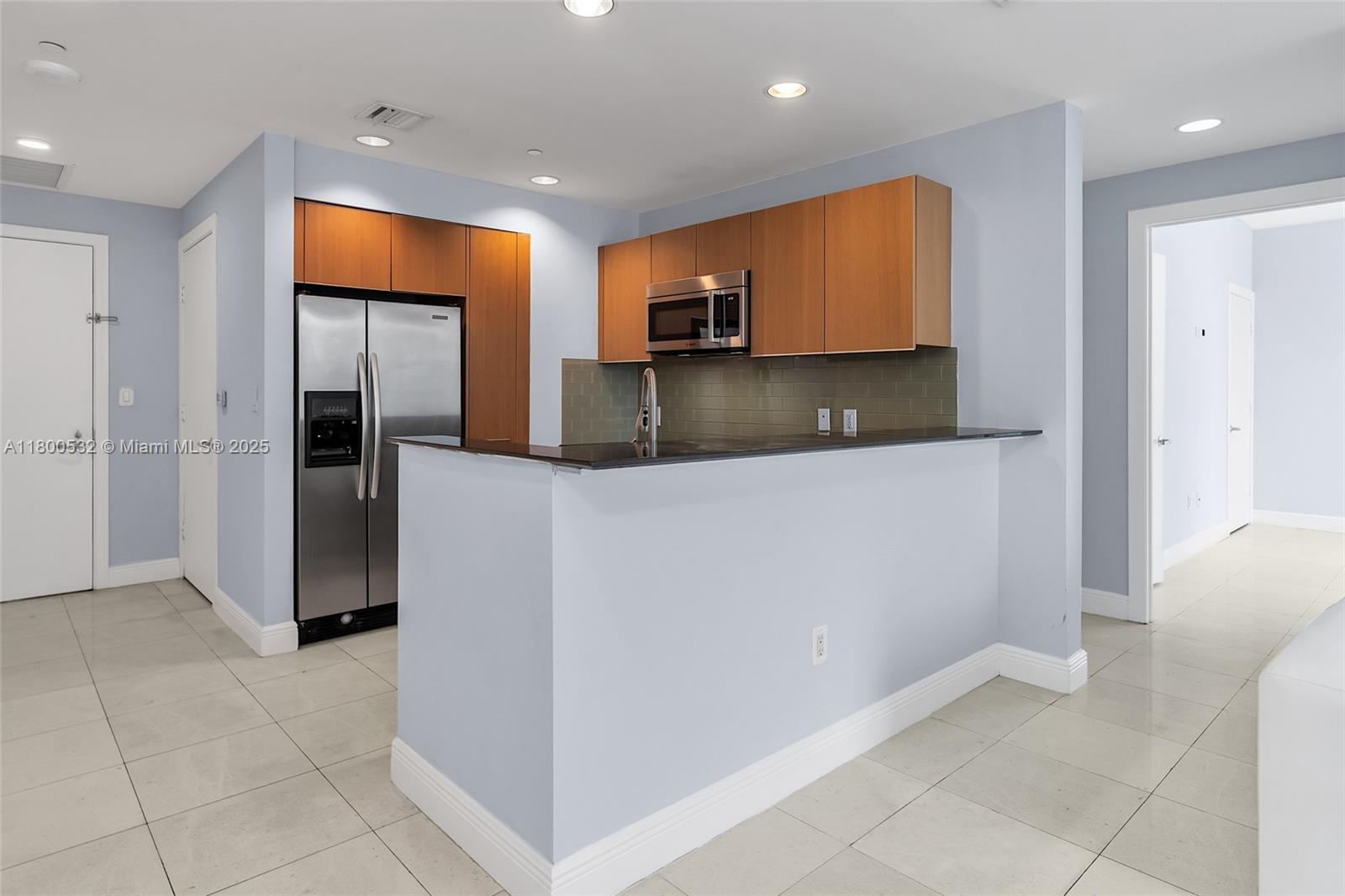1060 Brickell Avenue, Unit 1811 Miami, FL 33131 - Photo 16 of 43 a kitchen with stainless steel appliances a refrigerator and a microwave