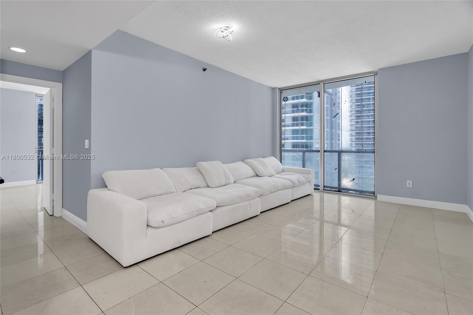 1060 Brickell Avenue, Unit 1811 Miami, FL 33131 - Photo 17 of 43 a living room with furniture and a large window