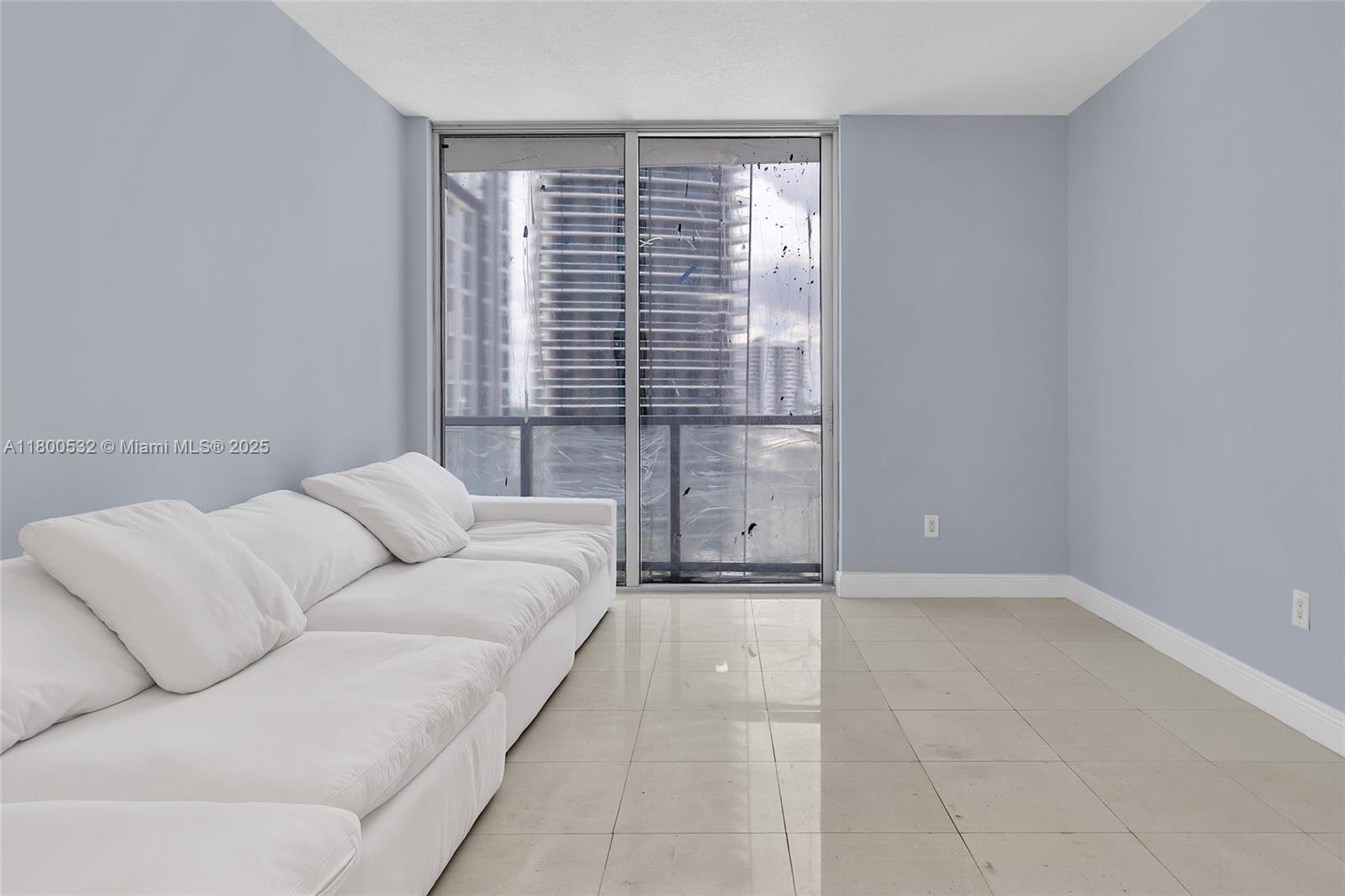 1060 Brickell Avenue, Unit 1811 Miami, FL 33131 - Photo 18 of 43 a living room with furniture and a window