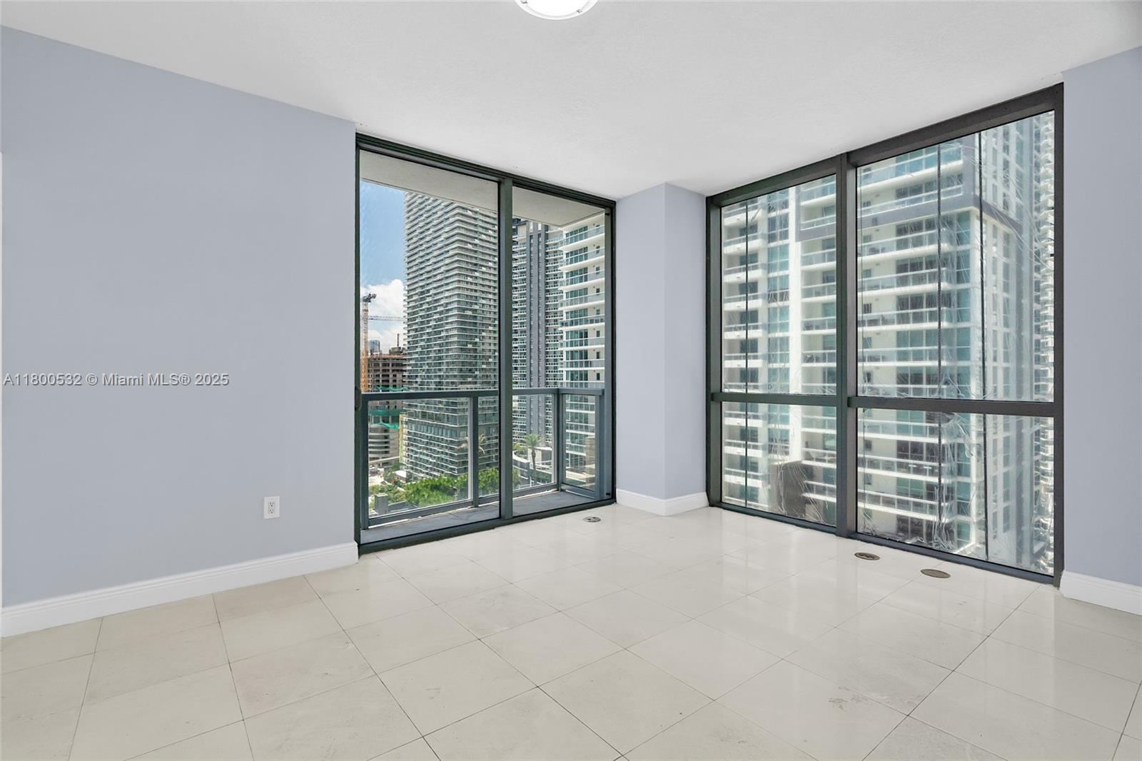 1060 Brickell Avenue, Unit 1811 Miami, FL 33131 - Photo 2 of 43 a view of an empty room with windows