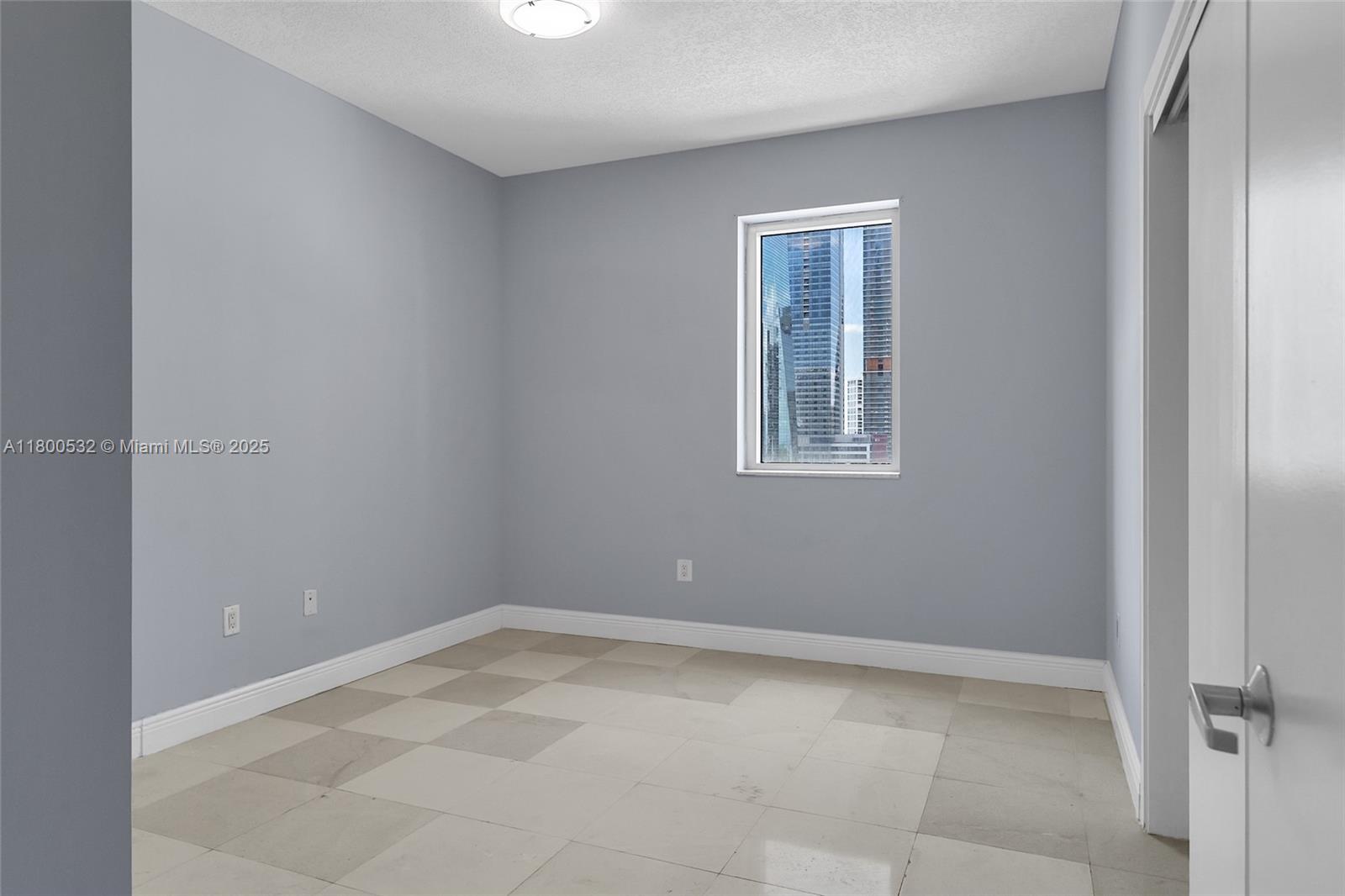 1060 Brickell Avenue, Unit 1811 Miami, FL 33131 - Photo 28 of 43 a view of an empty room with a window
