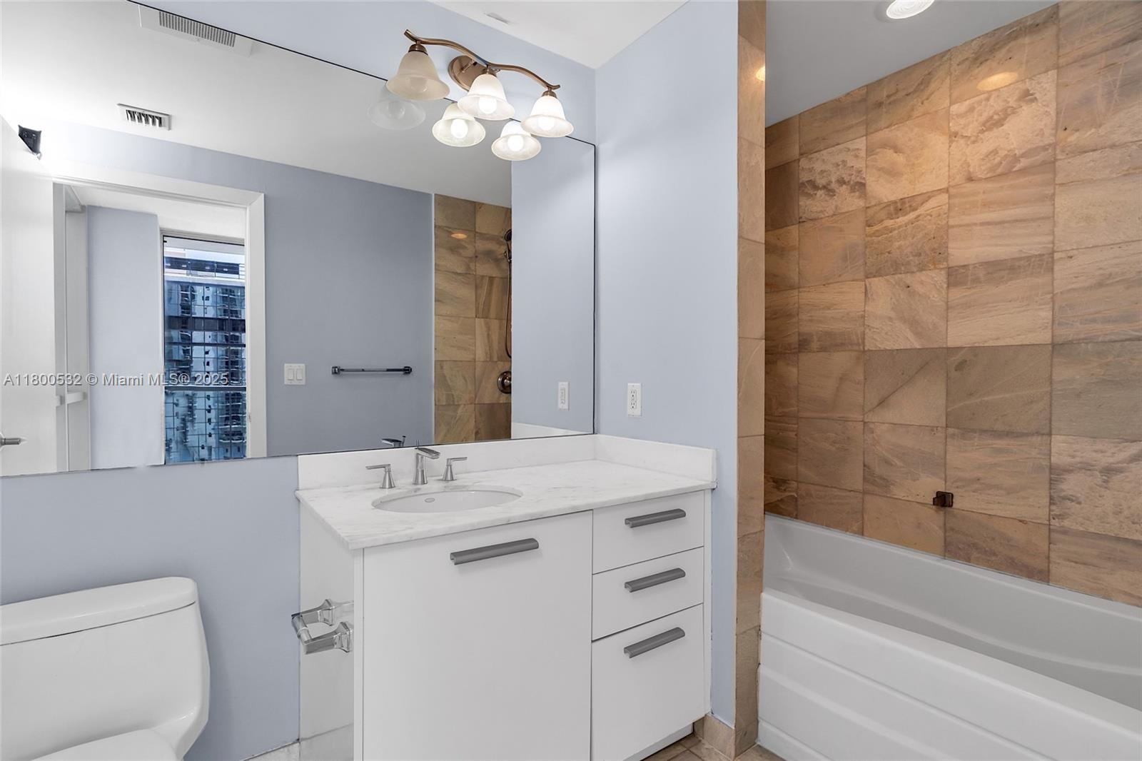 1060 Brickell Avenue, Unit 1811 Miami, FL 33131 - Photo 34 of 43 a bathroom with a sink a toilet and shower