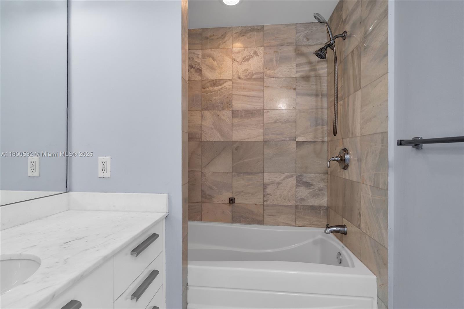 1060 Brickell Avenue, Unit 1811 Miami, FL 33131 - Photo 35 of 43 a bathroom with a bathtub and shower