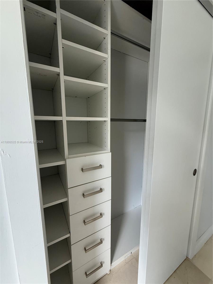 1060 Brickell Avenue, Unit 1811 Miami, FL 33131 - Photo 42 of 43 a view of walk in closet with empty racks