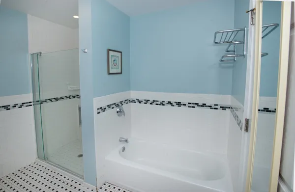 a bathroom with a bathtub and a shower