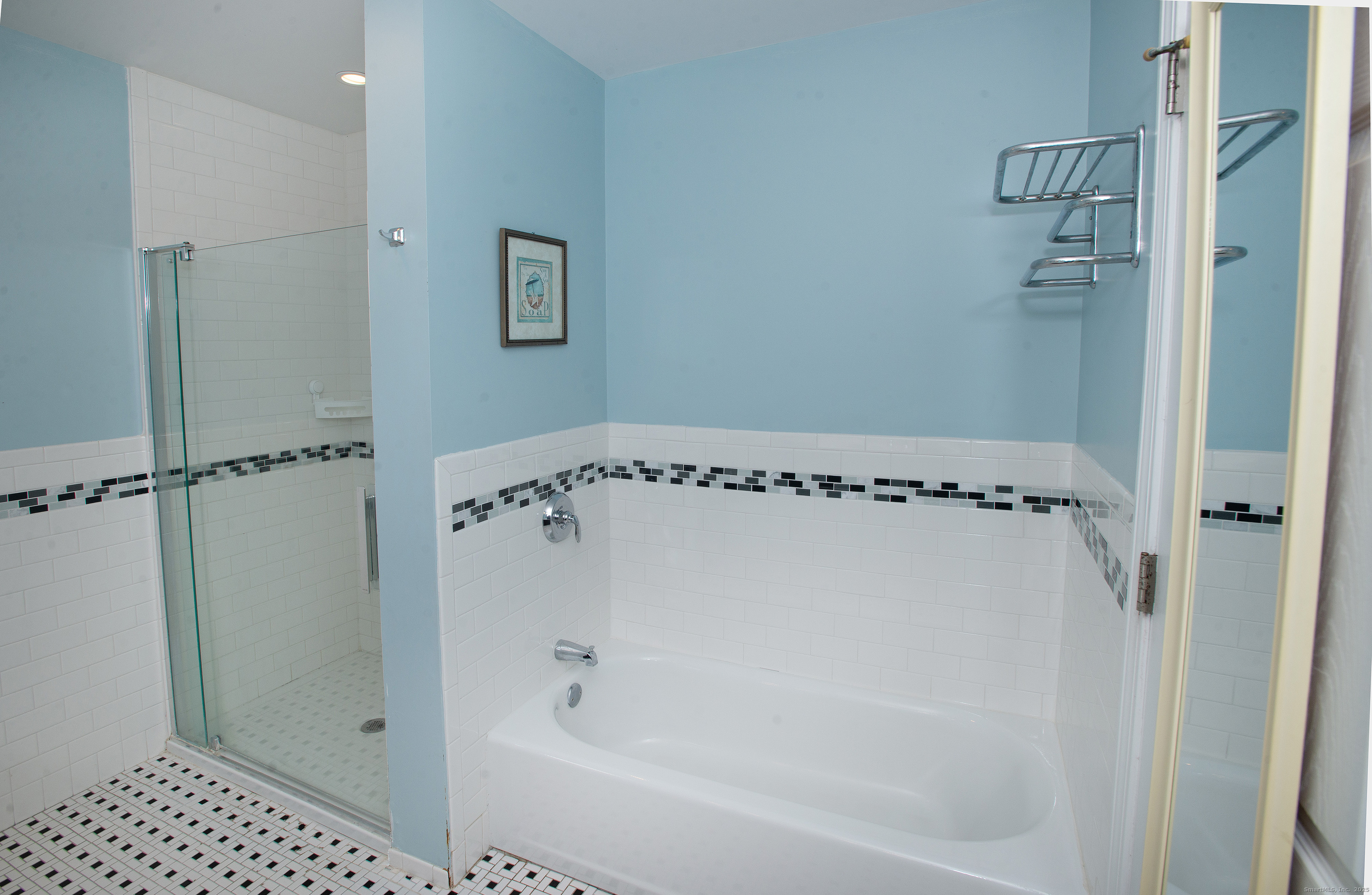 a bathroom with a bathtub and a shower