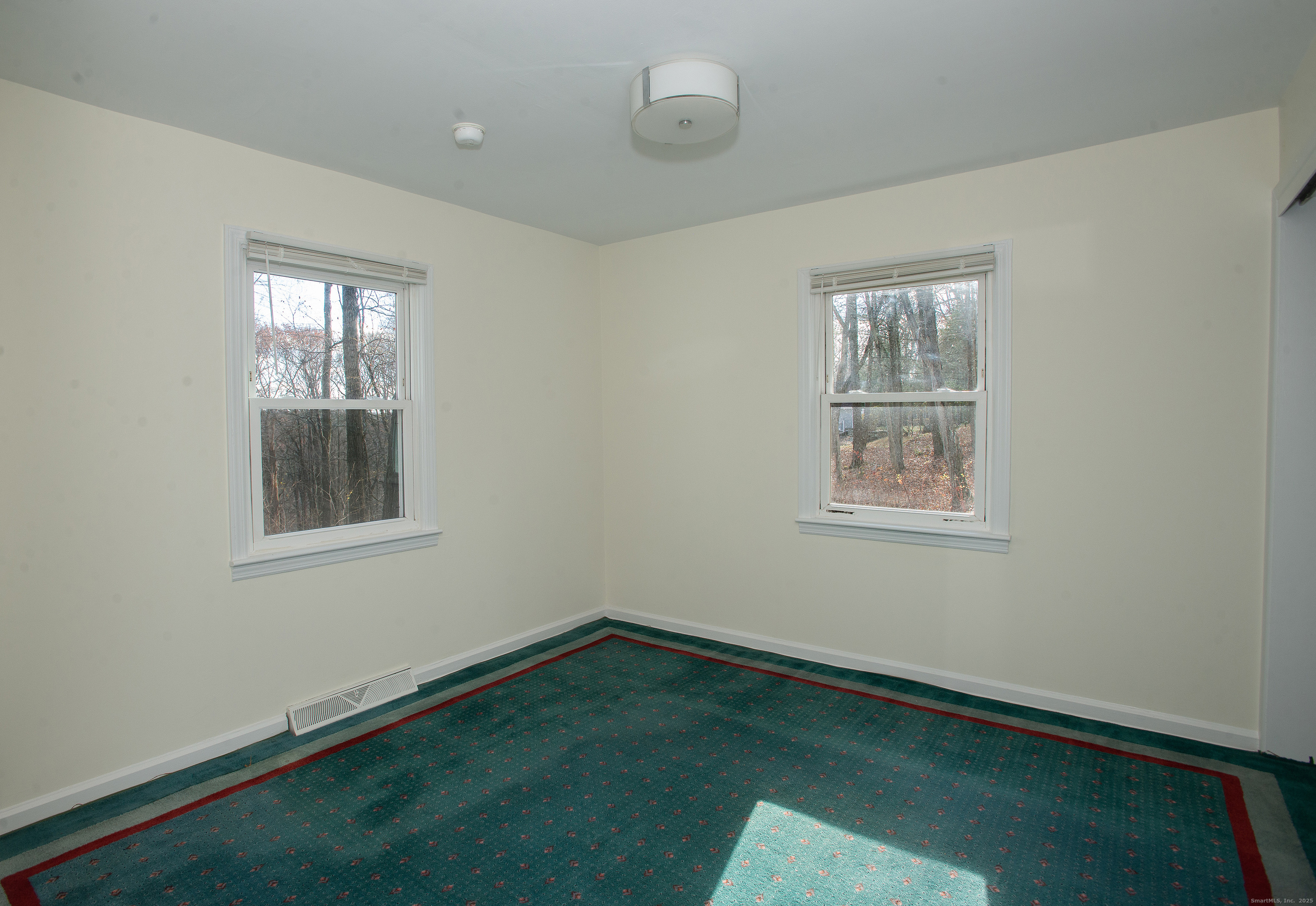 180 Peaceable Ridge Road Ridgefield, CT 06877 - Photo 21 of 28 an empty room with a window