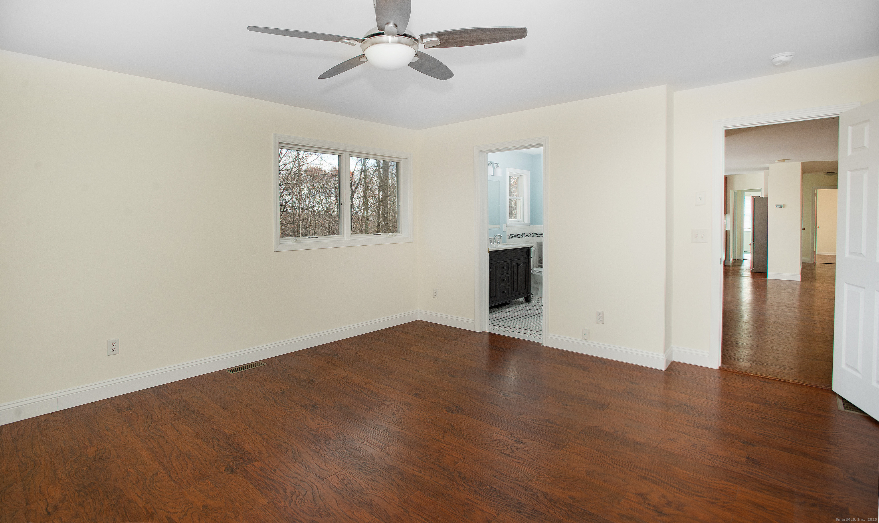 180 Peaceable Ridge Road Ridgefield, CT 06877 - Photo 22 of 28 an empty room with wooden floor closet and windows