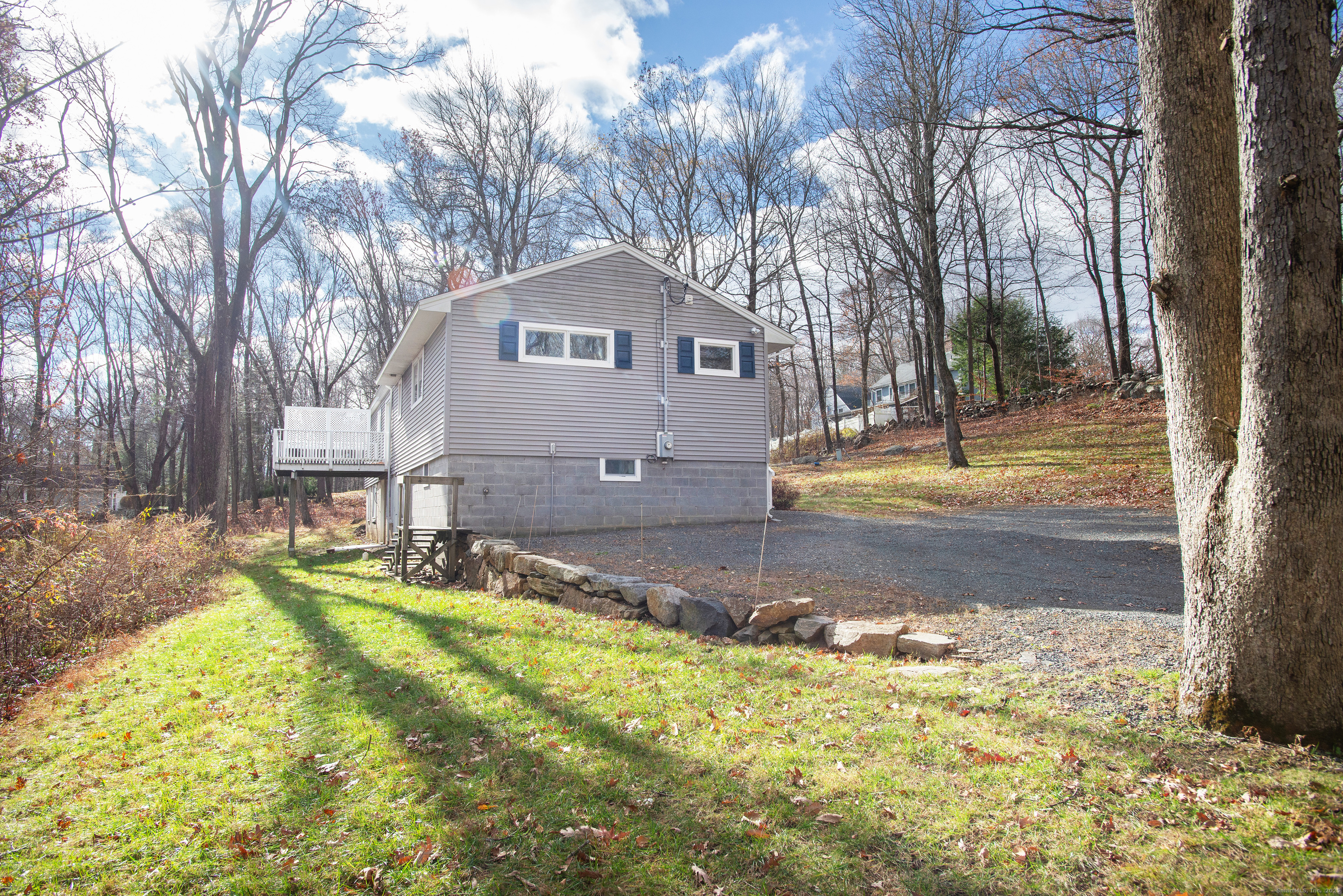 180 Peaceable Ridge Road Ridgefield, CT 06877 - Photo 26 of 28 a front view of a house with a yard covered with snow