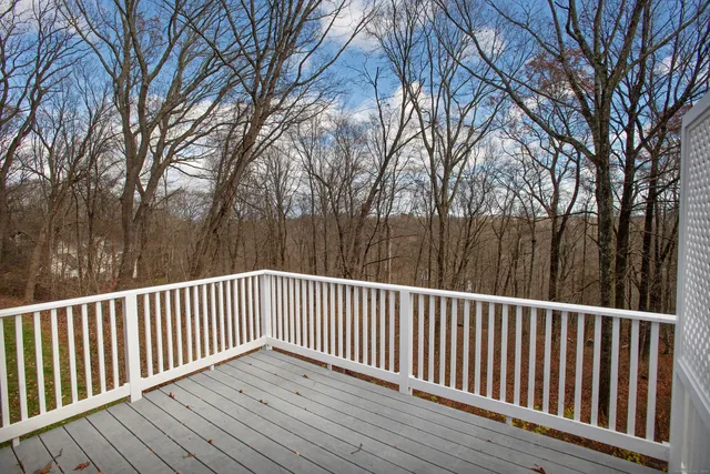 a view of balcony with wooden floor and fence