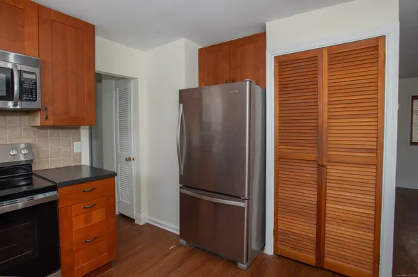 a kitchen with stainless steel appliances granite countertop a refrigerator and a stove top oven