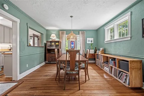 a view of a dining room with furniture window and wooden floor