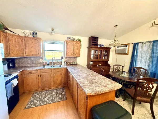a kitchen with a sink a counter top space and appliances