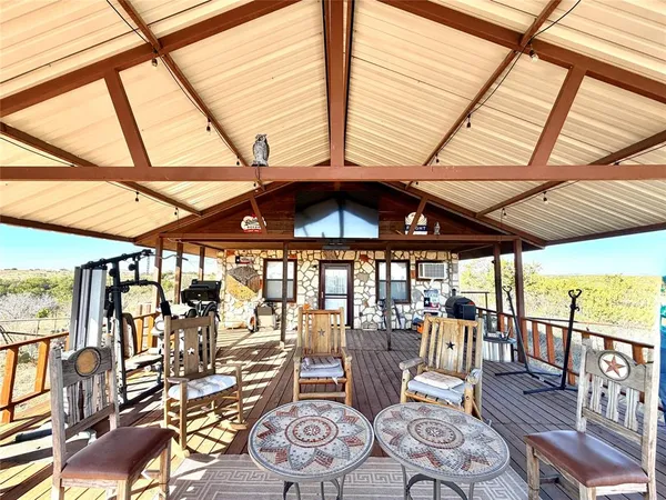 a living room with furniture and large windows