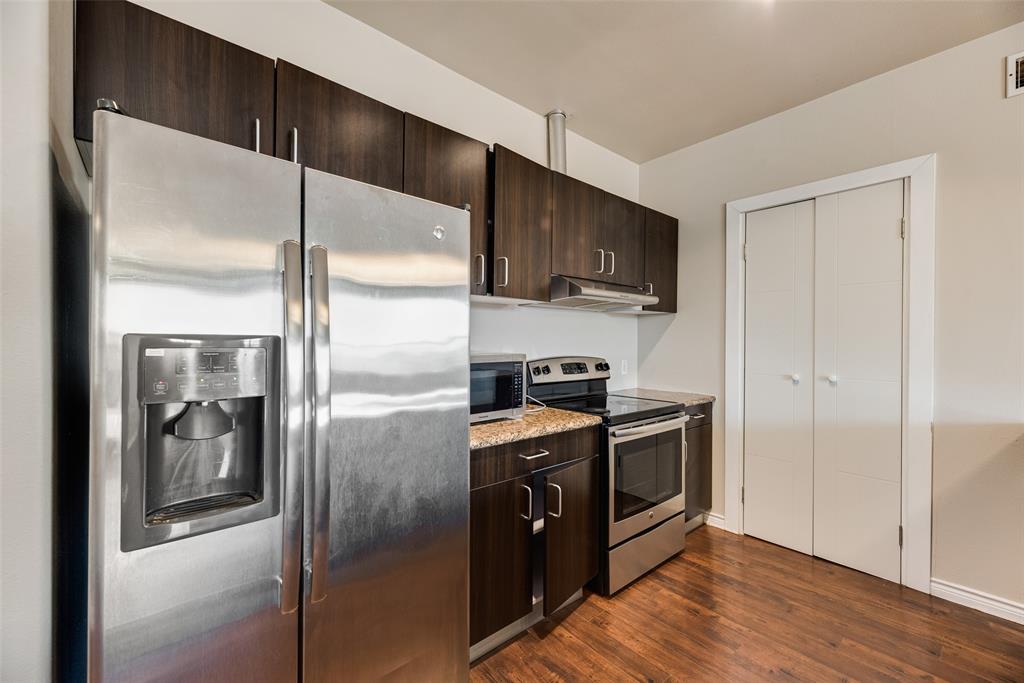 1100 West Trinity Mills Road, Unit 2040 Carrollton, TX 75006 - Photo 6 of 21 a kitchen with a refrigerator a sink and a stove top oven