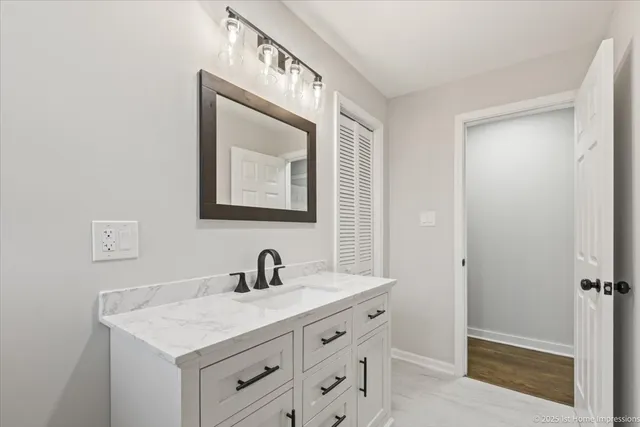 a bathroom with a sink vanity and a mirror