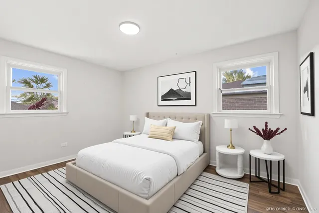 a bedroom with a bed and a painting on the wall