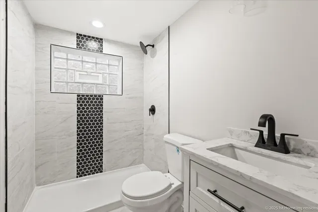 a bathroom with a sink a toilet and shower