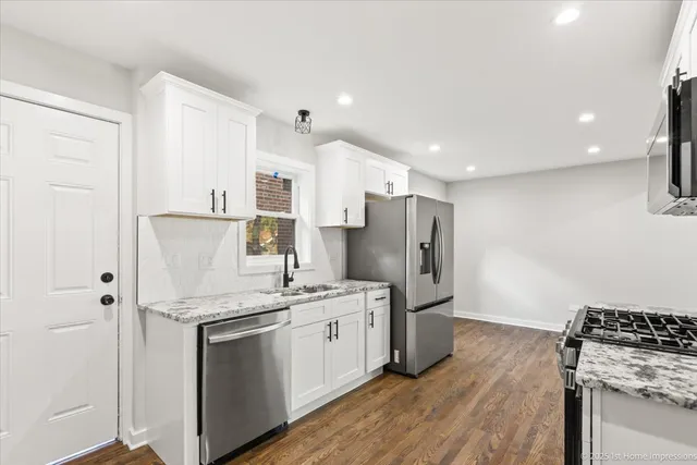 a kitchen with stainless steel appliances a refrigerator sink and stove