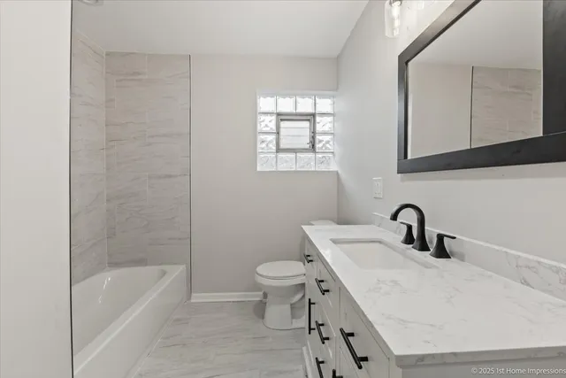 a bathroom with a sink a toilet and bathtub