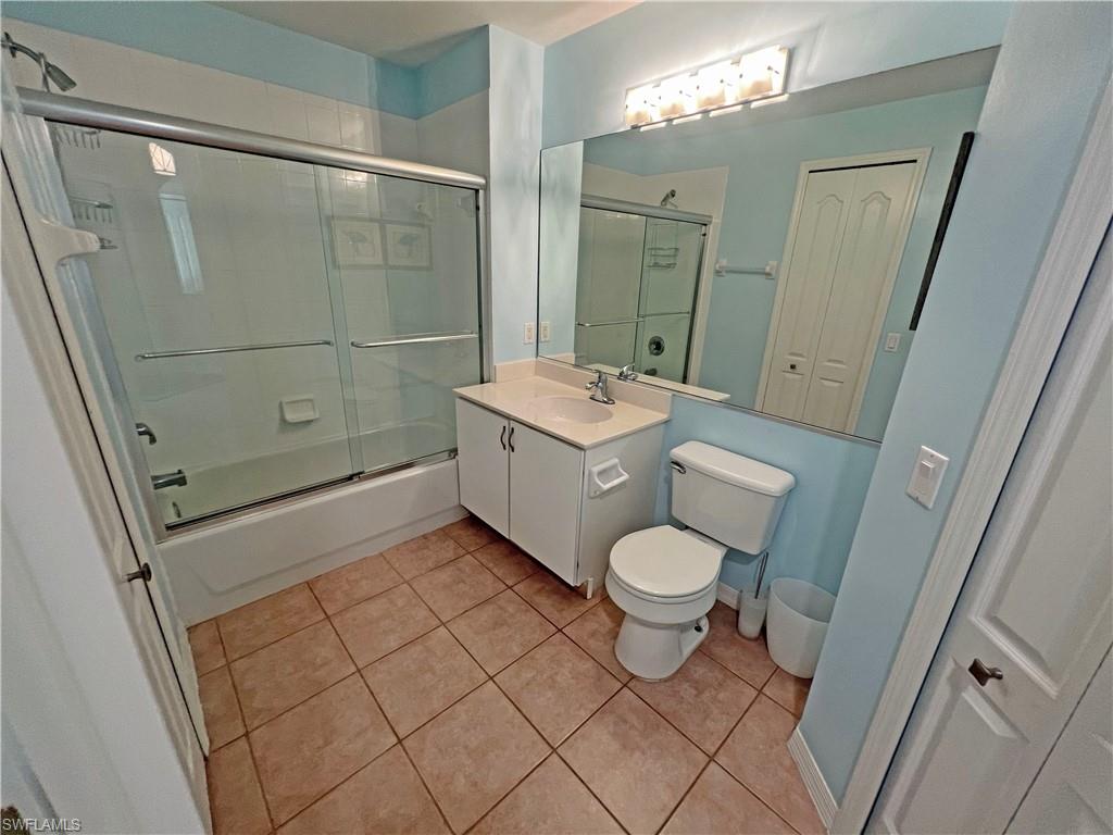 9261 Spring Run Boulevard, Unit 2407 Estero, FL 34135 - Photo 11 of 24 Bathroom with tile patterned flooring, enclosed tub / shower combo, vanity, and toilet