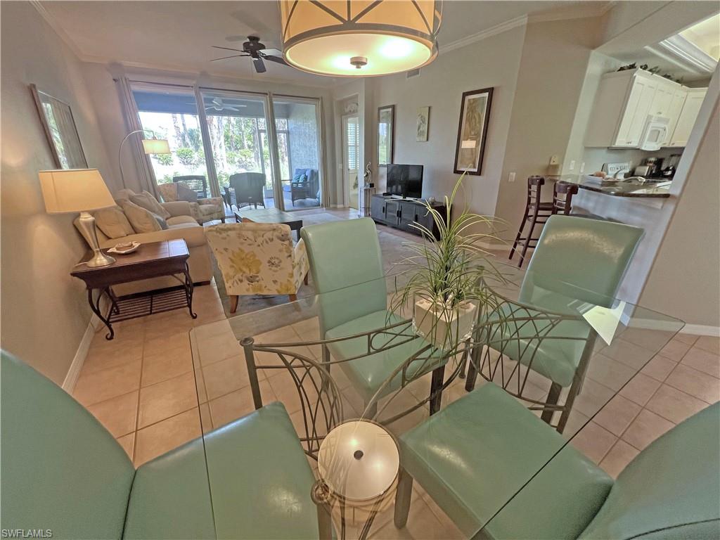 9261 Spring Run Boulevard, Unit 2407 Estero, FL 34135 - Photo 12 of 24 Tiled dining room with ceiling fan and crown molding