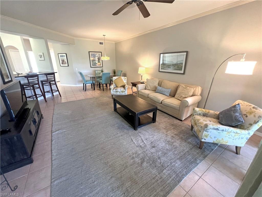 9261 Spring Run Boulevard, Unit 2407 Estero, FL 34135 - Photo 3 of 24 Living room with tile floors, ceiling fan, and ornamental molding
