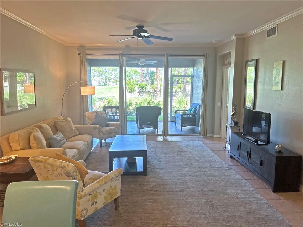 9261 Spring Run Boulevard, Unit 2407 Estero, FL 34135 - Photo 4 of 24 Living room featuring ornamental molding, plenty of natural light, and ceiling fan