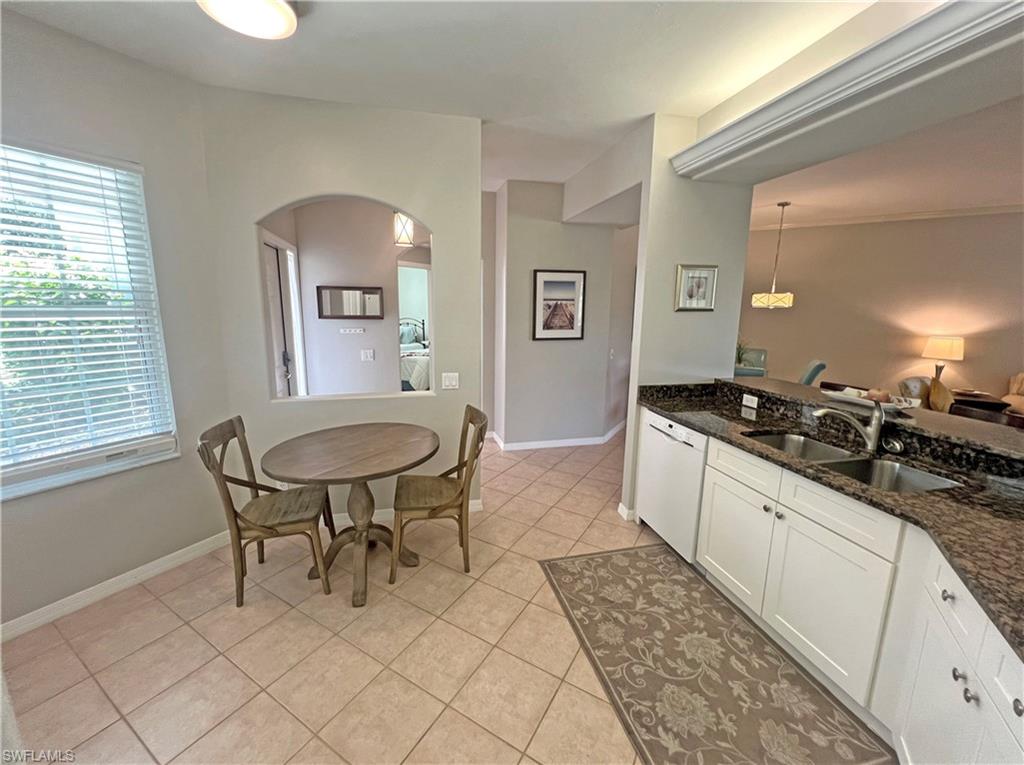 9261 Spring Run Boulevard, Unit 2407 Estero, FL 34135 - Photo 7 of 24 Kitchen with granite countertops, sink, white modern cabinets, crown lighting, and light tile floors