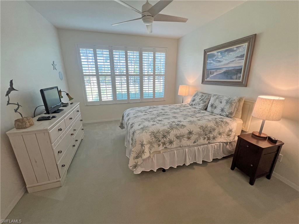 9261 Spring Run Boulevard, Unit 2407 Estero, FL 34135 - Photo 8 of 24 Bedroom with light carpet, ceiling fan, and baseboards