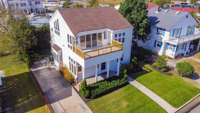 a aerial view of a house with a yard and potted plants