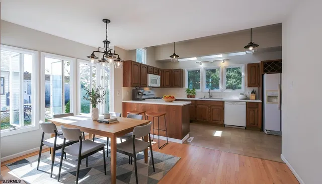 a kitchen with a table chairs sink and cabinets