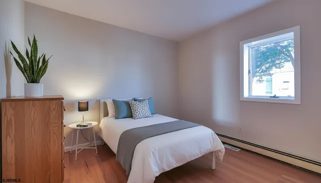 a bedroom with a bed and a window