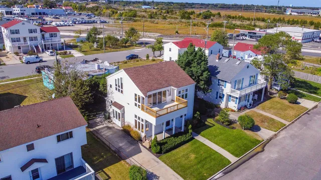 an aerial view of residential houses with outdoor space and swimming pool