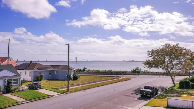 a view of a lake with a house in the background