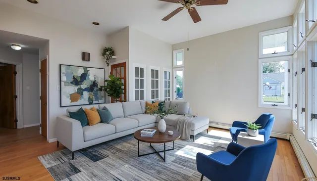 a living room with furniture and wooden floor