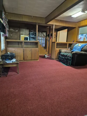 a bedroom with furniture and a flat screen tv