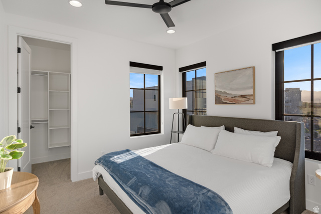 5367 Cyan Lane St. George, UT 84790 - Photo 11 of 49 Bedroom featuring ample natural light from multiple windows, a ceiling fan, recessed lighting, and a closet with built-in shelving