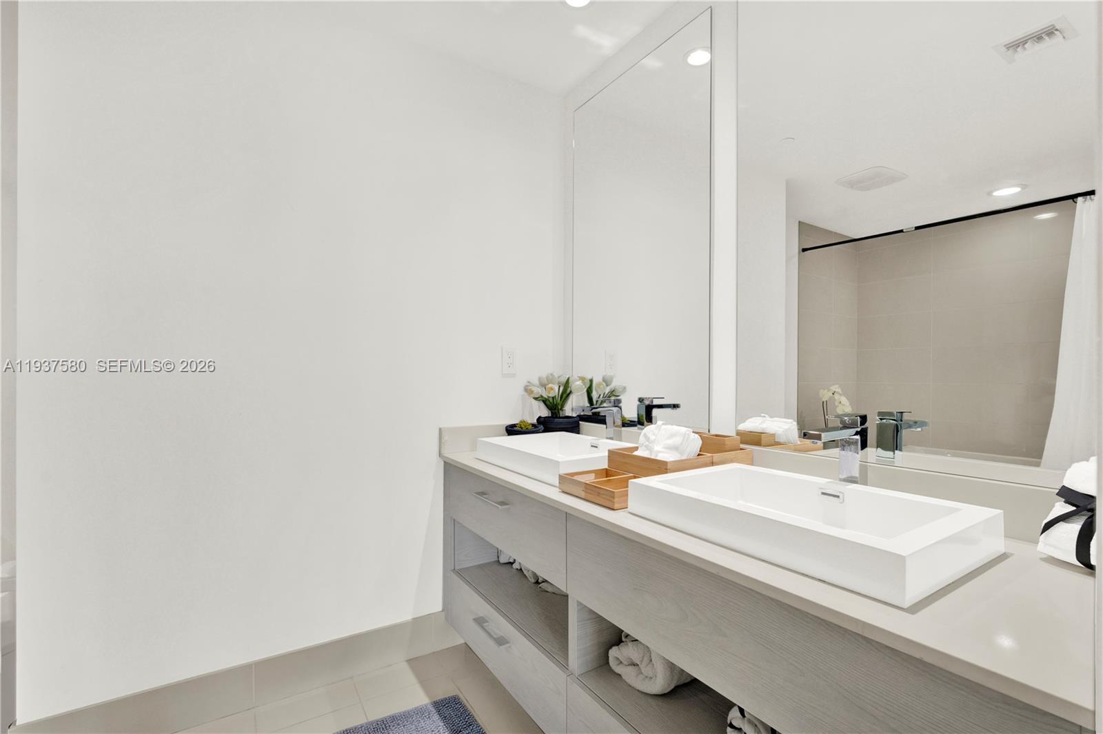 45 Southwest 9th Street, Unit 1609 Miami, FL 33130 - Photo 15 of 39 a bathroom with a sink and a mirror